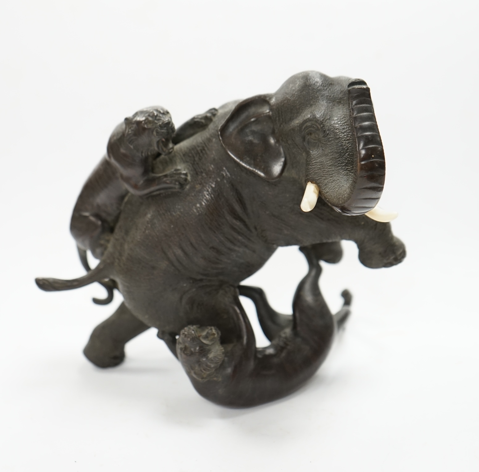 After Genryusai Seiya (1868-1912), a 19th century Japanese Meiji period cast bronze group of an elephant being attacked by tigers, seal mark, 14cm high. CITES Submission reference P5SHZWF1. Condition - good